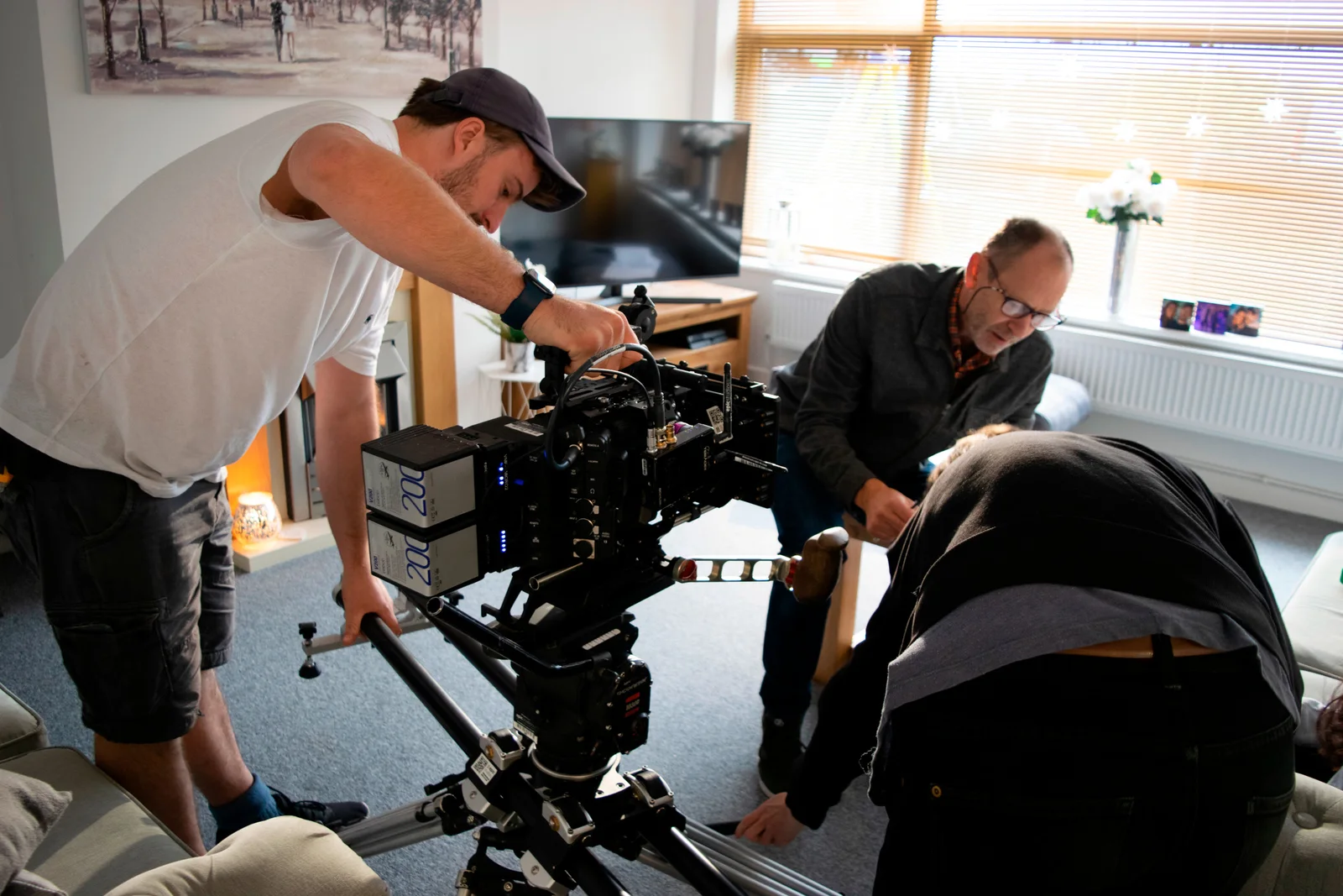 Film crew setting up a camera for a production